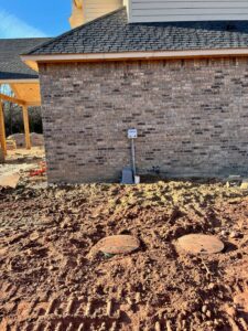 control panel for an aerobic septic system mounted on a new home with a plastic aerator cover in Arcadia Oklahoma