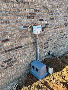 control panel for an aerobic septic system mounted on a new home with a plastic aerator cover in Arcadia Oklahoma
