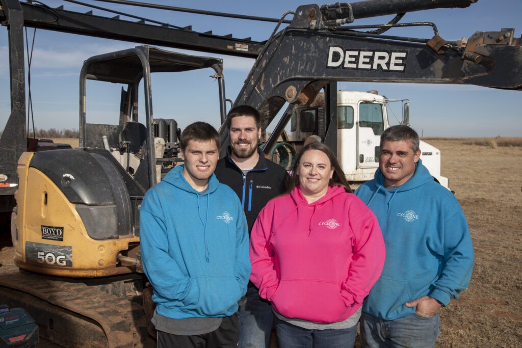 The Rohrs family poses for a photo on a septic system job site in Enid, Oklahoma. From left to right pictured are, Cody, Austin, Dawn and Michael Rohrs.
