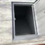 open door looking down into an EZ Entry precast concrete storm shelter installed by Cyclone Septics