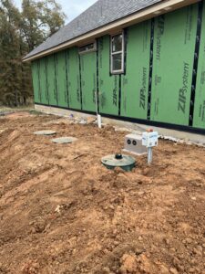 A NuWater aerobic septic system installed for a new home in Edmond Oklahoma by Cyclone Septics with the control panel mounted on the tank