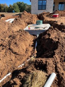 88e4c18ba5fa83d520231105-54-cidz3h | Cyclone Septic & Plumbing A precast concrete septic tank installed by Cyclone Septics for a new home in Guthrie Oklahoma