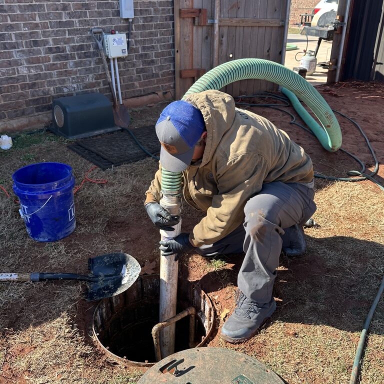Septic technician pumping a residential septic tank in Oklahoma