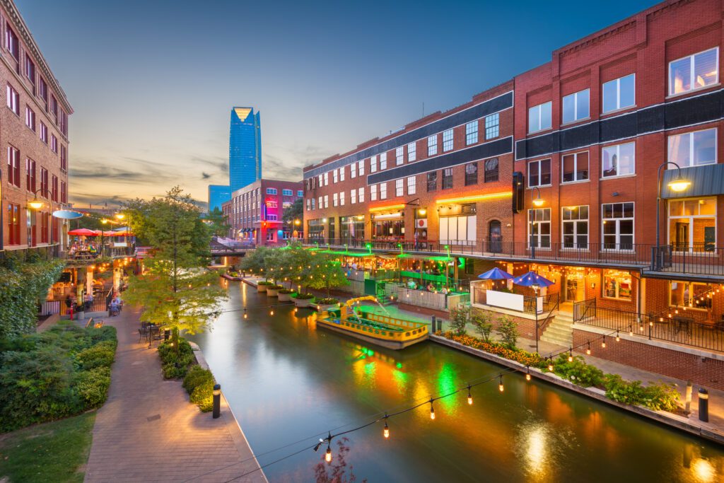 Bricktown Canal at sunset with downtown Oklahoma City skyline in the background