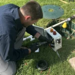 Cyclone Septics technician servicing an aerobic septic control panel in Guthrie, OK