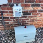 Septilink Installation for 24/7 Septic System Monitoring | Cyclone Septic & Plumbing Septilink septic monitoring system installed next to aerobic control panel on residential home in Edmond, OK