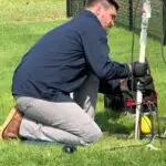 Aerobic Septic System Service in Guthrie, OK | Cyclone Septic & Plumbing Cyclone technician servicing an aerobic septic system in Guthrie, Oklahoma