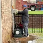 Aerobic Septic System Repair in Oklahoma City, OK | Cyclone Septic & Plumbing Cyclone Septic & Plumbing technician repairing an aerobic septic system control panel in Oklahoma City