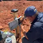Commercial Septic System Installation in Edmond, OK | Cyclone Septic & Plumbing Cyclone technician wiring a control panel for a commercial septic system near Edmond, Oklahoma