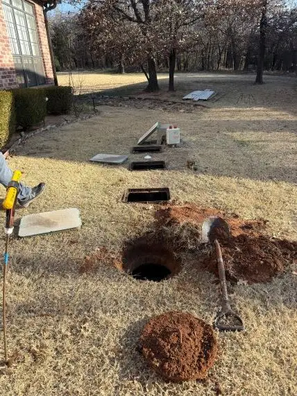 Open septic tank access points during a septic inspection in Edmond, Oklahoma