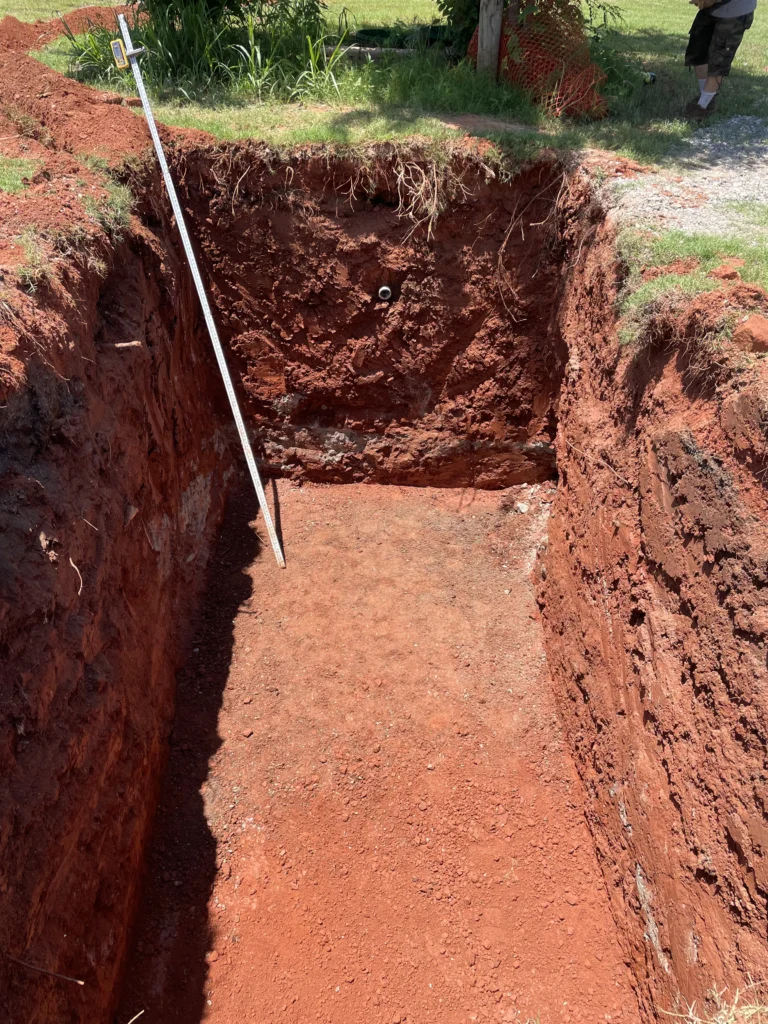 Oklahoma red dirt and soil exposed during a septic system excavation