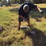 Septic Tank Locating Service - Jones, Oklahoma | Cyclone Septic & Plumbing Cyclone Septic & Plumbing technician using a locator camera to find a buried septic tank in Jones, OK
