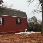 Storm Shelter Installation – Jones, Oklahoma | Cyclone Septic & Plumbing Underground storm shelter installation backfilled near a home in Jones, OK