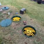 Septic System Inspection in Choctaw, OK | Cyclone Septic & Plumbing Open septic tank access points during a septic inspection in Choctaw, Oklahoma