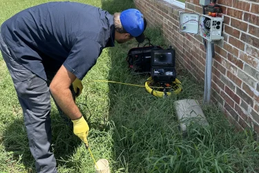 Cyclone Septics technician inspecting a septic and plumbing line at an Oklahoma home with professional camera equipment.
