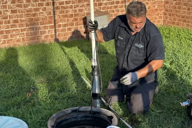 Cyclone Septics technician servicing an aerobic septic control panel in Arcadia, OK