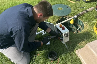 Cyclone Septics technician servicing an aerobic septic control panel in Guthrie, OK