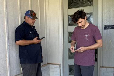Cyclone Septics technician meeting a homeowner at the front door.