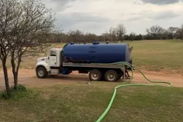 Cyclone Septic & Plumbing pump truck servicing a residential septic system in Crescent, Oklahoma