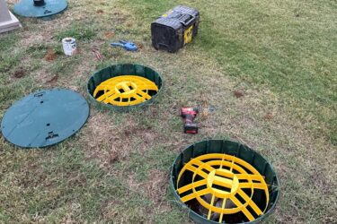 Open septic tank access points during a septic inspection in Choctaw, Oklahoma