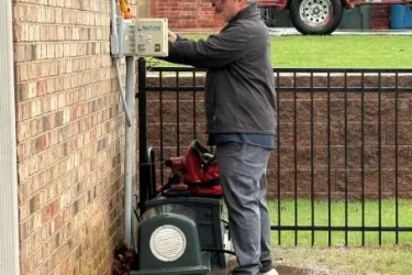 Cyclone Septic & Plumbing technician repairing an aerobic septic system control panel in Oklahoma City