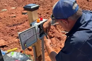 Cyclone technician wiring a control panel for a commercial septic system near Edmond, Oklahoma