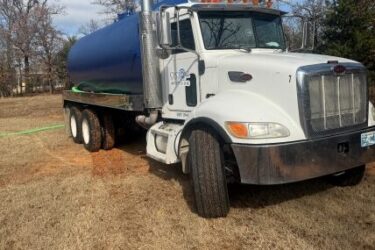 Residential septic system inspection in Choctaw, Oklahoma with tank access points exposed to evaluate the condition and operation of the septic system