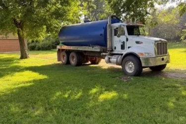 Cyclone septic pumping truck at a residential property in Edmond, Oklahoma