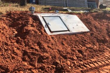 In-ground storm shelter installed on a rural property in Blanchard, Oklahoma