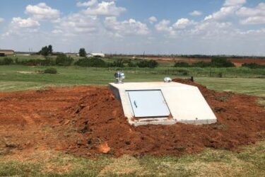 In-ground storm shelter installed on a rural property in Piedmont, Oklahoma