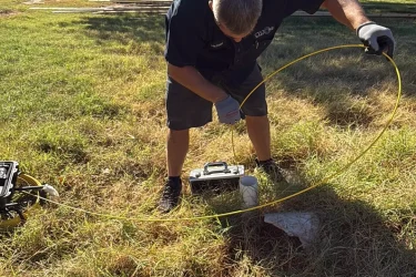 Cyclone Septic & Plumbing technician using a locator camera to find a buried septic tank in Jones, OK